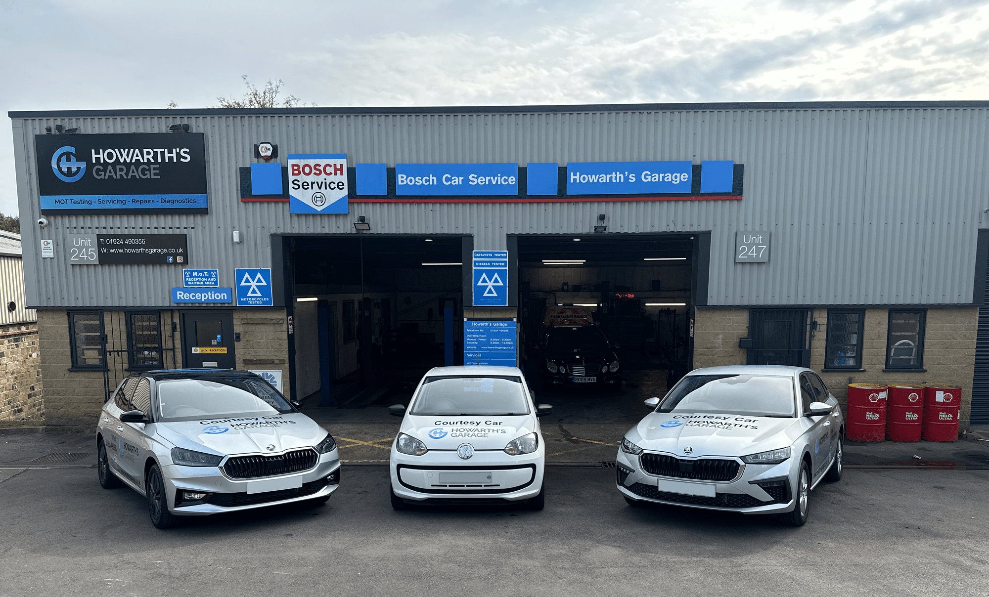 Howarths Garage with three courtesy cars outside